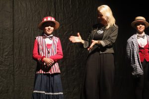Kids On Stage actor in costume receiving applause from a teacher during a children’s theater performance in Santa Monica.